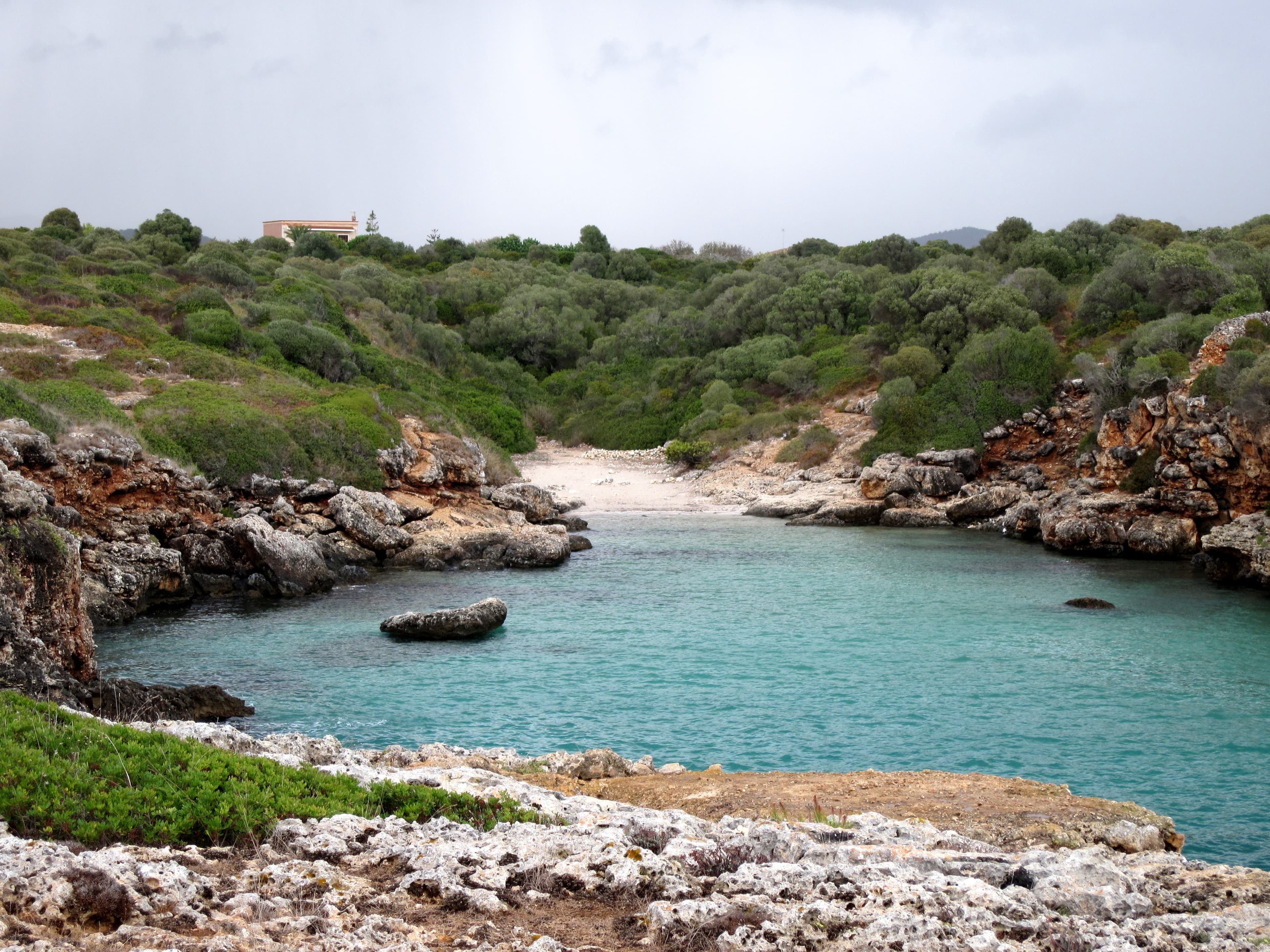 Sheltered rocky cove and turquoise water on Mallorca’s east coast near Porto Cristo