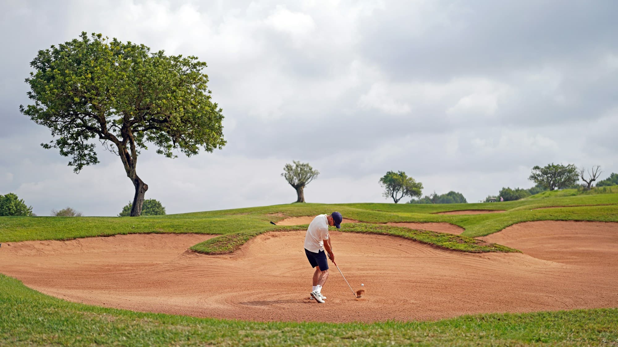 Golf on a Mallorca course, with bunker, fairway and open sky
